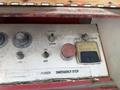 Control panel of a 2010 International 4300 featuring various buttons and knobs labeled for power emergency stop and basket control