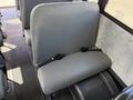 Interior view of a 2011 Freightliner B2 showing a gray vinyl school bus seat with a lap belt and no visible occupants