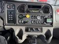 Dashboard of a 2015 Freightliner M2 featuring various controls gauges and a radio system