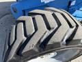Close-up of a large, rugged tire with distinctive deep tread patterns designed for outdoor use on machinery