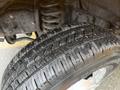 Close-up of a tire from a 2021 Ford Econoline showing detailed tread pattern and slight water droplets on the surface