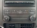 The image shows the dashboard controls of a 2013 Ford F-250 SD including air conditioning and ventilation dials