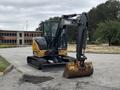 A 2017 John Deere 50G excavator with a yellow and black color scheme featuring a large bucket attachment in the front