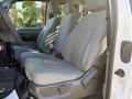 Interior view of a 2012 Ford F-350 SD showing the front seats with light gray upholstery and a simple design
