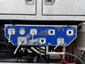 A blue control panel with various valves and gauges is mounted on the side of a 2013 International Workstar 7500 truck