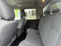 Interior view of the back seat of a 2016 RAM 1500 with gray fabric upholstery and headrests visible