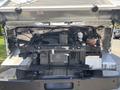 2012 Ford Econoline with the hood raised showing the engine compartment and various components including the radiator and hoses