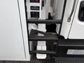 A side view of a 2021 Freightliner M2 106 showing textured black metal steps leading up to the cab with visible control switches mounted beside them