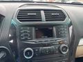 The interior dashboard of a 2016 Ford Explorer featuring an infotainment system with multiple buttons and a digital display showing the time and date.
