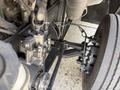 Close-up of the front suspension and steering components of a 2017 Freightliner MT45 showing metal joints and connections