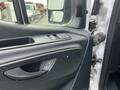 Close-up of the interior door panel of a 2025 Mercedes-Benz Sprinter featuring window controls and a handle