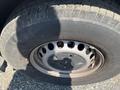 A close-up of a tire from a 2022 Mercedes-Benz Sprinter showing the tread and a steel wheel rim with multiple holes