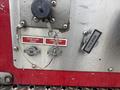 A close-up of the control panel of a 2006 E-One Typhoon featuring labeled valves for foam flush drain and a drain valve with a chain attached