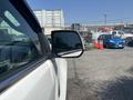 Side view mirror of a 2017 Chevrolet Colorado with reflective surface showing a partially visible blue car in the background