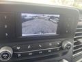 Dashboard display of a 2024 Ford Transit showing a rearview camera feed with a view of the surrounding area
