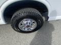Close-up of a chrome wheel with a large tire on a 2022 GMC Savana showcasing the tread and detailed rim design