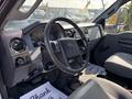 Interior view of a 2018 Ford F-750 showing the steering wheel dashboard and seats in a gray color scheme