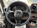 Steering wheel of a 2023 Mercedes-Benz Sprinter featuring controls and the Mercedes-Benz logo