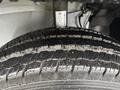 A close-up view of a tire's tread from a 2023 RAM Promaster 3500 showing detailed grooves and patterns with some dirt and moisture on the surface