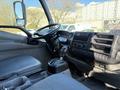 Interior of a 2014 Hino 195 showing the steering wheel dashboard gear shift and seating area