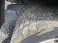 Close-up of a worn tire on a 2009 Dodge Ram 5500 showing deep treads and dirt accumulation