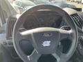 Steering wheel of a 2017 Ford Transit with a Ford logo and dashboard displaying speed and other indicators