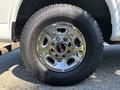 A close-up of a chrome wheel with the GMC logo on a 2019 GMC Savana showcasing the tire tread and shiny rim