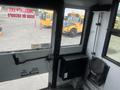 Interior view of a 2007 Freightliner B2 showing the driver's compartment with the door and controls visible