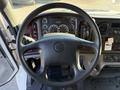 Steering wheel and dashboard of a 2012 Freightliner M2 106 showing gauges and controls