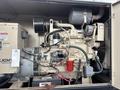 A 2005 Katolight SED60FPJ4 generator featuring a large engine block a radiator and various attached components including hoses and electrical connections