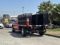A red 2013 RAM 2500 truck with a black flatbed trailer equipped with a fire extinguisher mounted on the side