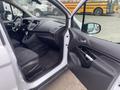 Interior view of a 2017 Ford Transit Connect showing the driver's side with a black steering wheel and cloth seats