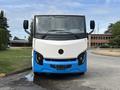A 2020 Lion Lion6 electric bus with a white and blue exterior featuring a circular logo on the front and large windshields for visibility