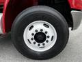 Close-up of a Goodyear G291 tire mounted on a wheel of a red 2011 International 4400 truck