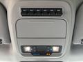 Overhead console of a 2023 Ford F-450 Super Duty featuring multiple auxiliary switches and two dome lights