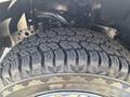 Close-up of a robust tire with deep treads mounted on a 2019 Ford F-150 showcasing durable rubber designed for off-road performance