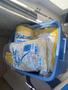 A blue storage bin holding packaged items labeled Falcon and other materials, likely boating supplies