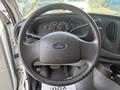 Steering wheel of a 2008 Ford Econoline with a Ford logo and instrument cluster in the background