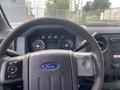 Interior view of a 2014 Ford F-350 SD showcasing the steering wheel dashboard gauges and control buttons