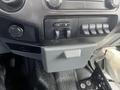 Interior view of a 2014 Ford F-250 SD dashboard showing the audio controls and several auxiliary switches