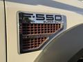 A close-up of the badge on a 2010 Ford F-550 featuring the text F-550 XLT SUPER DUTY and V3 POWER STROKE with a mesh grille design