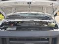 The image shows the engine bay of a 2008 Ford Econoline with the hood raised displaying the engine components and various fluids