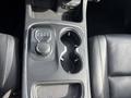 Close-up of the center console of a 2015 Dodge Durango showing the gear selector knob and two cup holders
