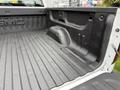 A 2016 GMC Sierra 1500 truck bed showing a textured black liner and the GMC logo embossed on the side