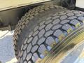 Close-up of two large, rugged tires mounted on a 2008 International DuraStar with deep tread patterns designed for heavy-duty use