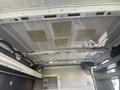 Interior view of the ceiling of a 2017 Ford Transit van showing metal ribs and insulation panels