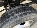Close-up of a rugged tire from a 2015 Ford F-550 showing detailed tread pattern and metal rim