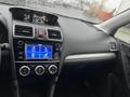 Dashboard of a 2016 Subaru Forester featuring a touchscreen display with audio and settings options along with climate control knobs