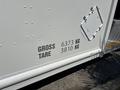 A 2012 Ford Econoline with specifications indicating gross weight of 6373 kg and tare weight of 3810 kg on the side panel