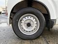 A close-up of the front wheel of a 2008 Suzuki Carry showing a silver alloy rim and a black tire with visible tread pattern